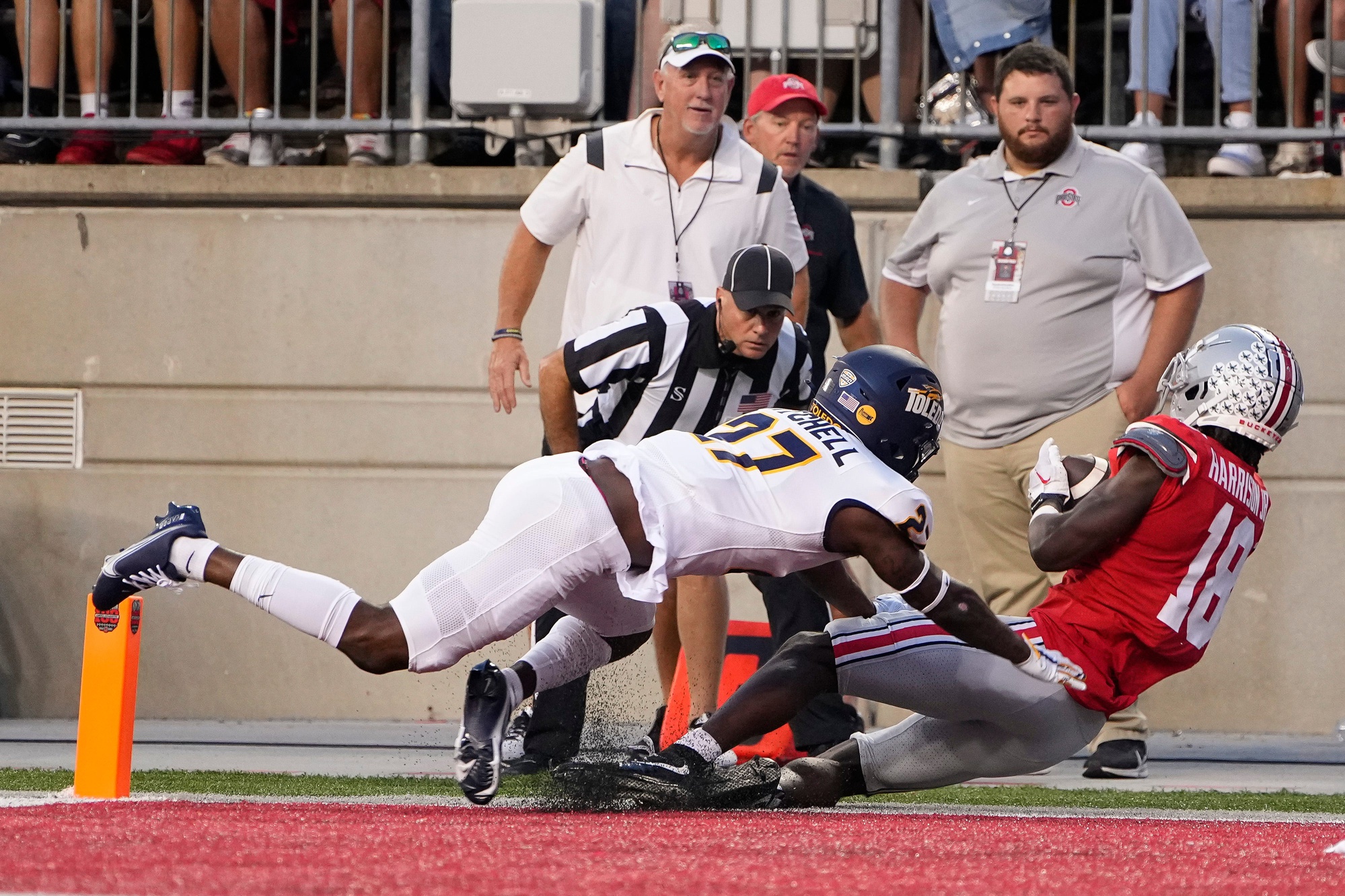 Sep 17, 2022; Columbus, Ohio, USA; Ohio State Buckeyes wide receiver Marvin Harrison Jr. (18) is hit by Toledo Rockets cornerback Quinyon Mitchell (27) as he catches a touchdown pass during the first half of the NCAA Division I football game at Ohio Stadium.